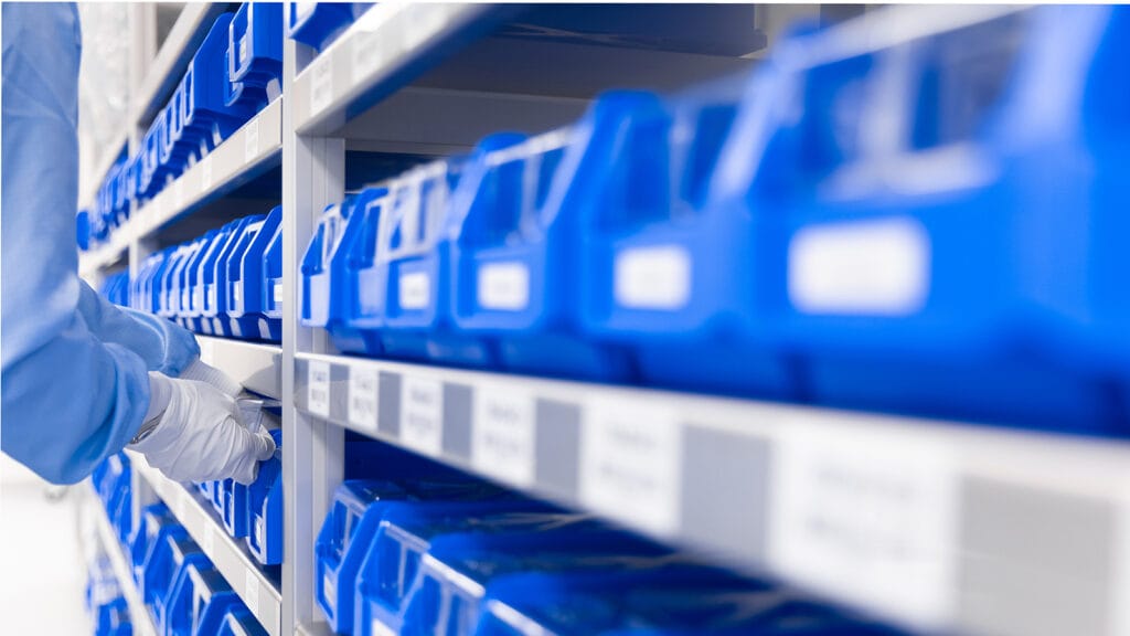 Open stock at hand cabinet filled with blue bins